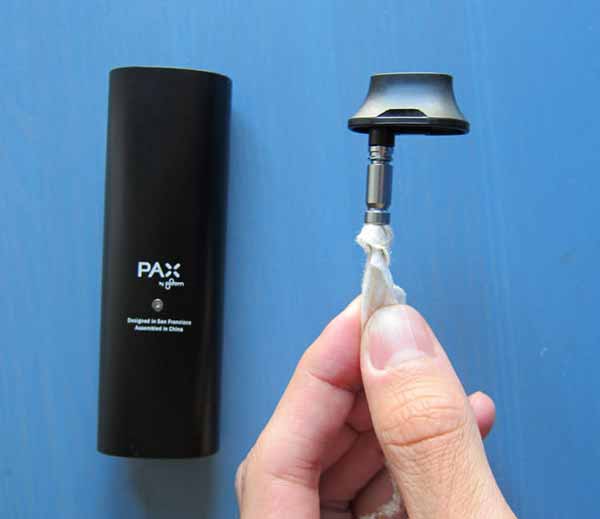 Using a pipe cleaner and alcohol wipe to clean the inside of the Pax mouth piece from cannabis resin and build-up.